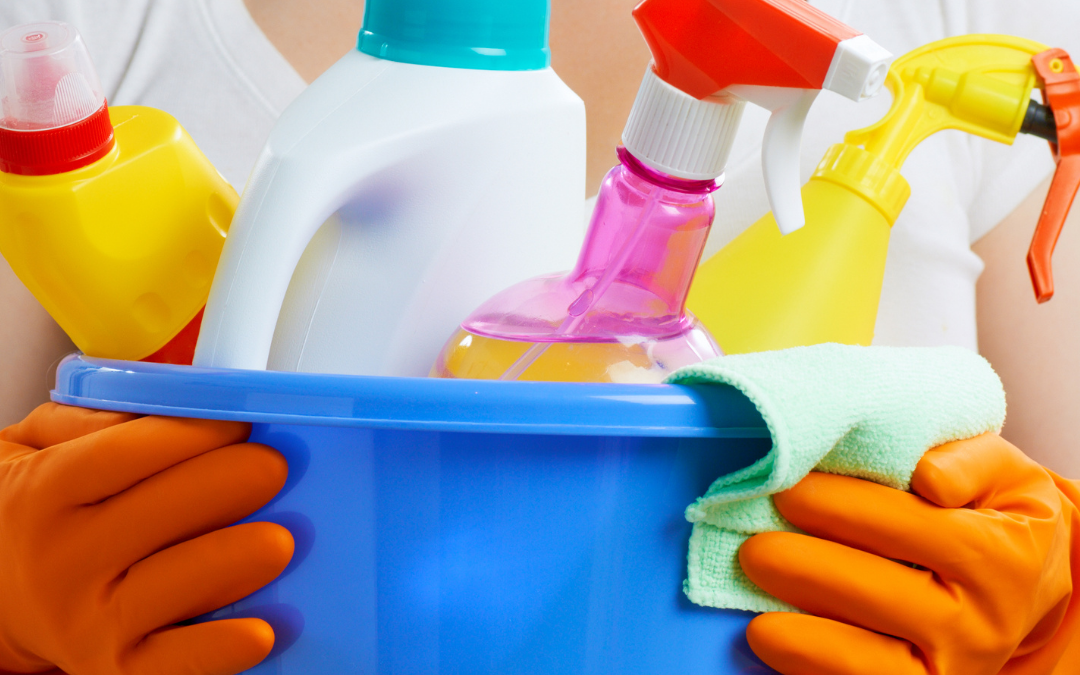 woman holding cleaning chemicals which contain xenoestrogens